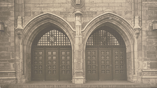 wide wooden doors of a collegiate gothic building