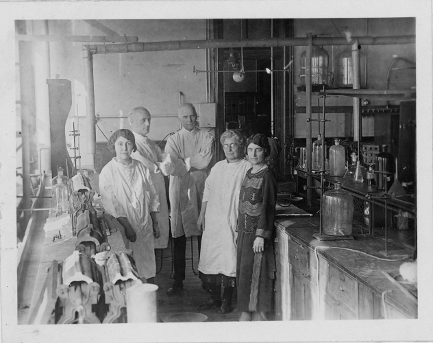 Reba Haner posing in a laboratory with other faculty members.